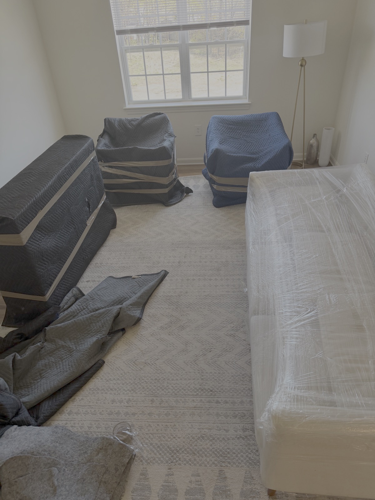 Chairs and furniture protected with moving blankets and stretch wrap